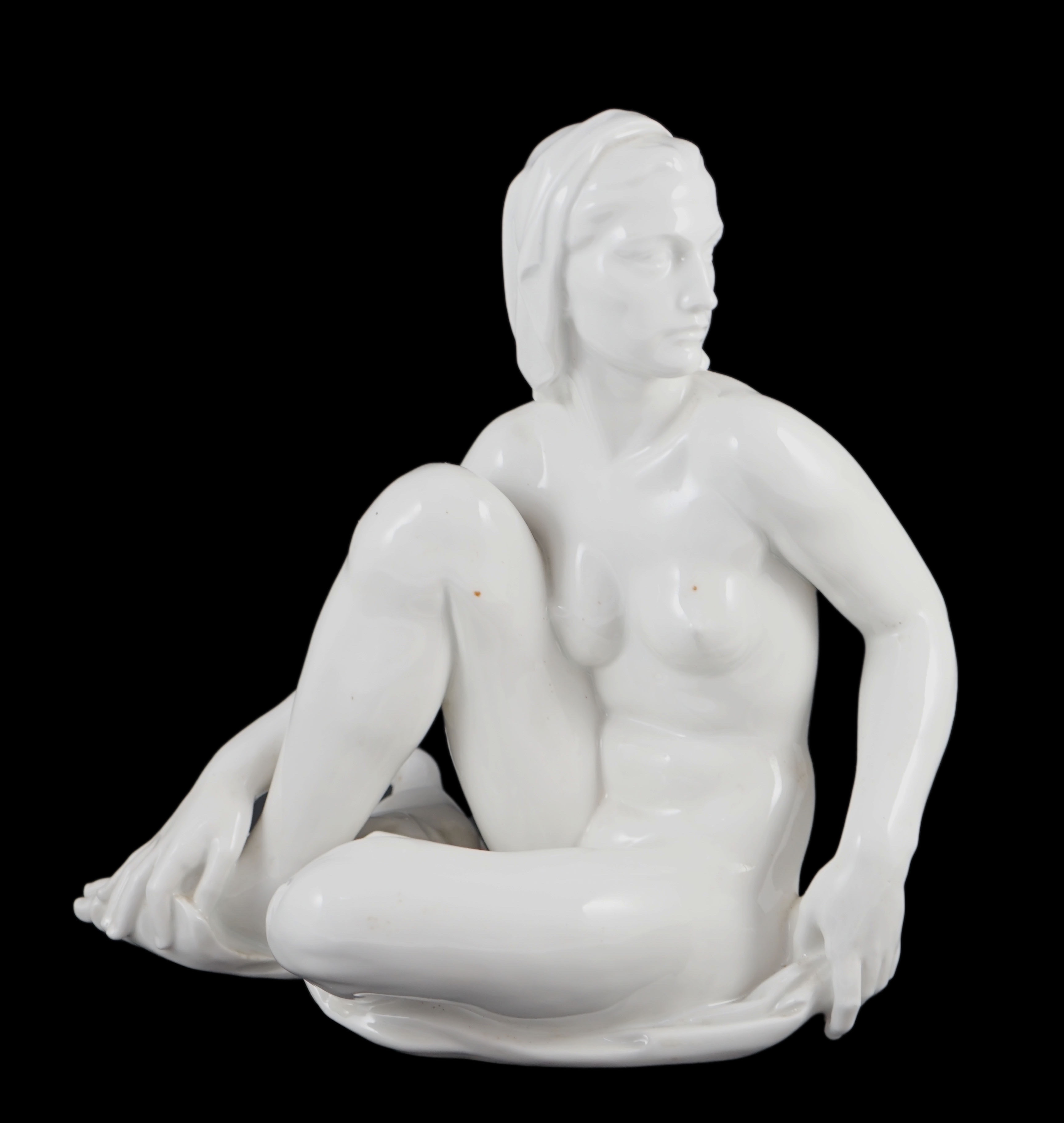 Robert Ullmann (1903-1966) for Meissen, a white glazed porcelain figure of a seated female nude, 31.5cm high